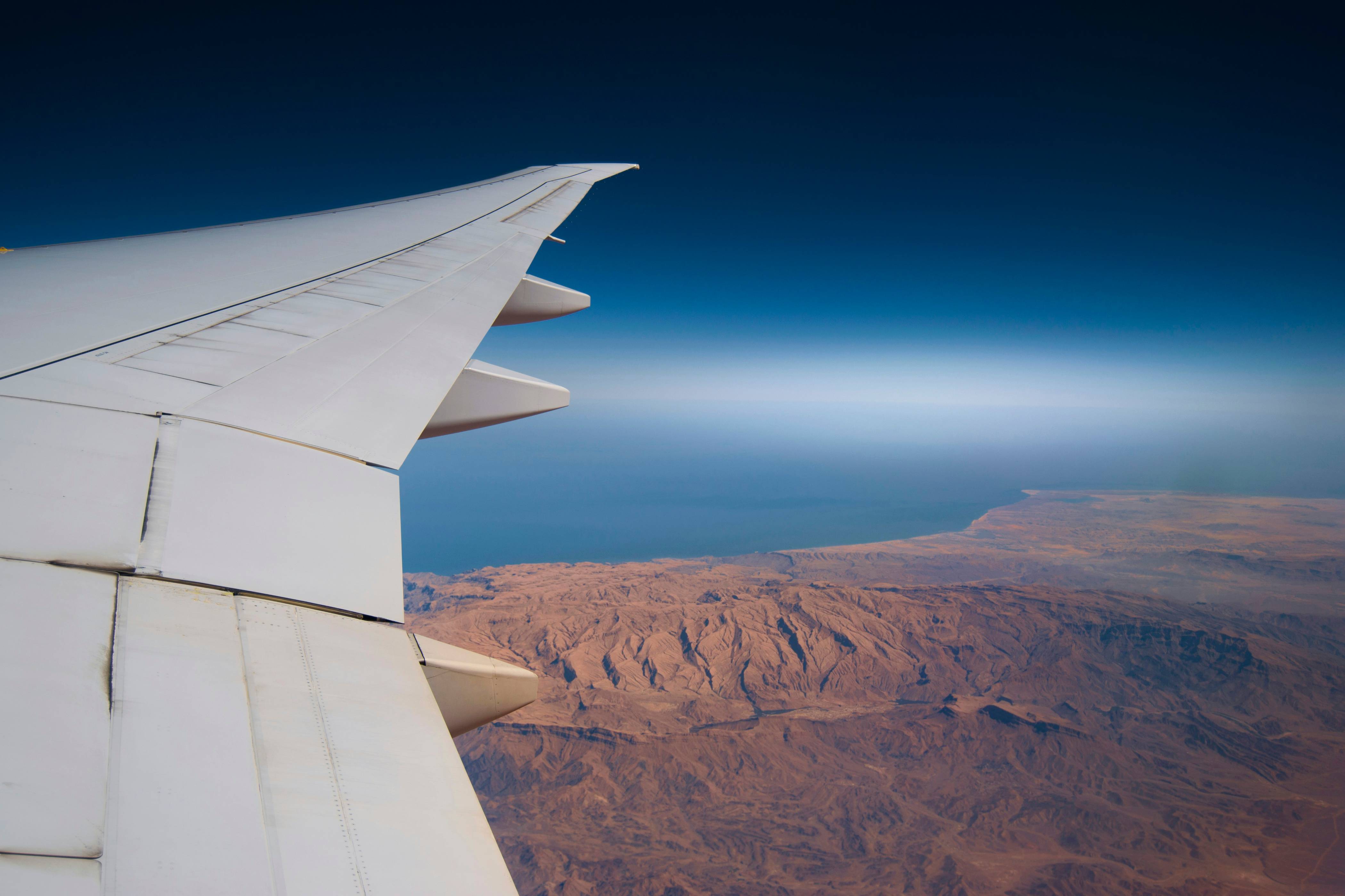 airplane in midair under blue sky