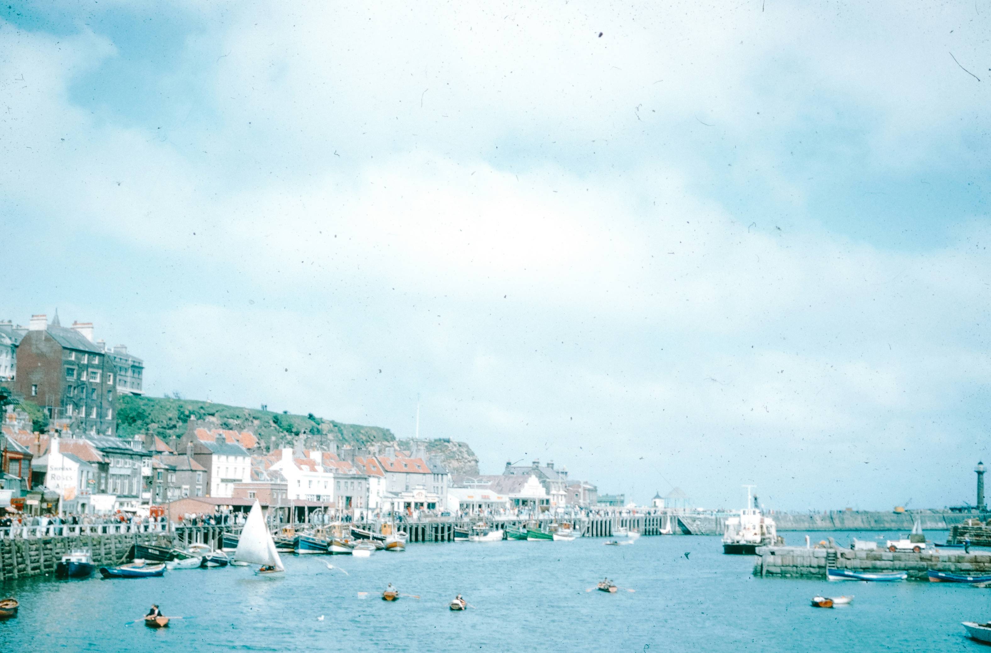 Coastal town with boats and buildings.