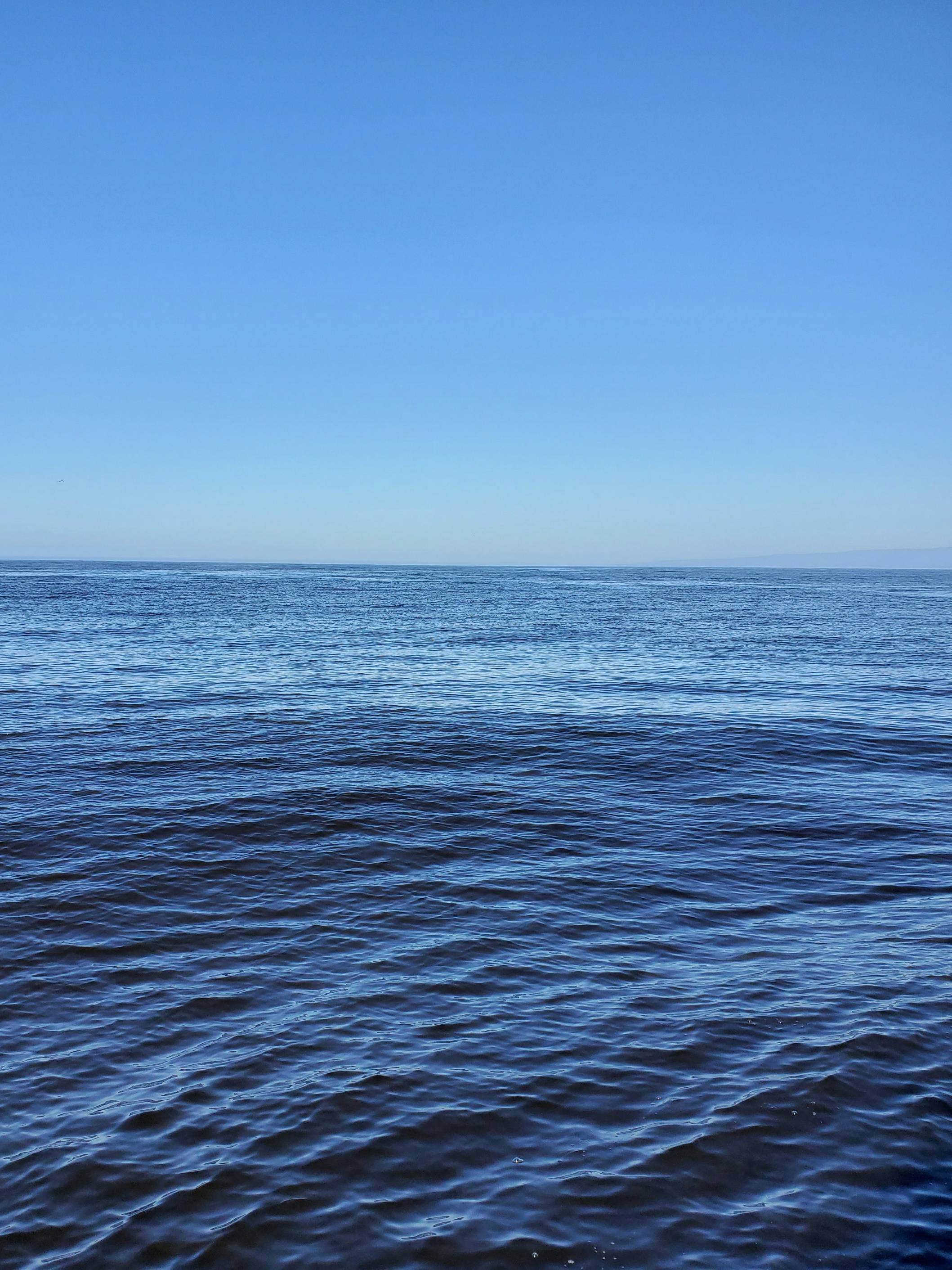 blue ocean water under blue sky during daytime