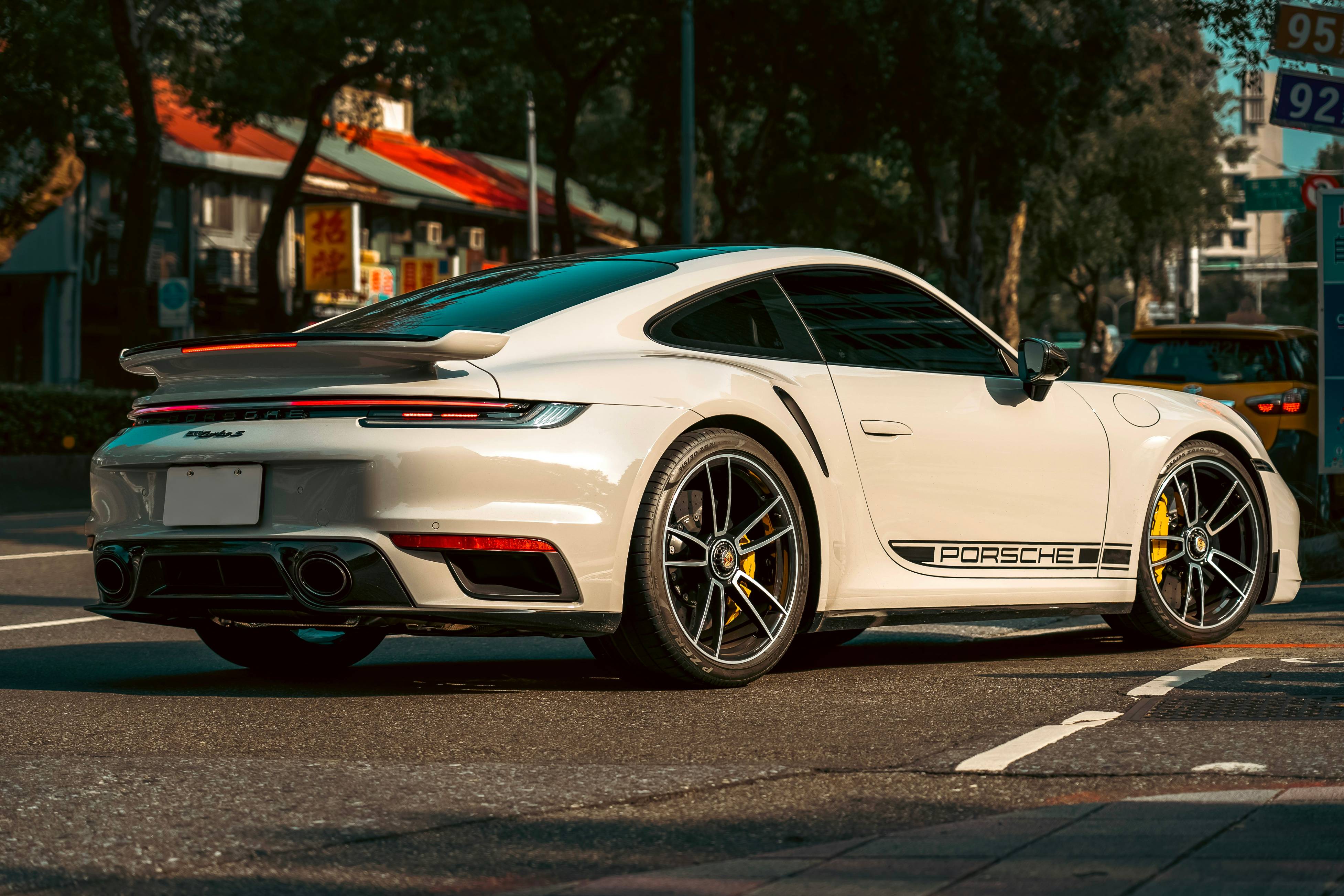 a white sports car parked on the side of the road